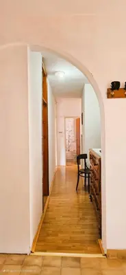 an archway in a room with a table and a chair at Biuk in Kotor