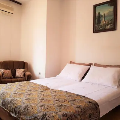 a bedroom with a bed and a couch at Biuk in Kotor
