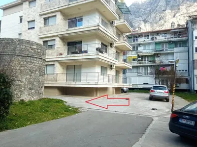 a car parked in a parking lot in front of a building at Minka 2 in Kotor