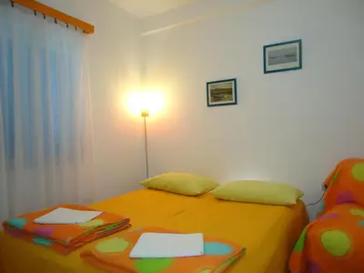 a bedroom with two twin beds and a lamp at Apartments Villa Petranović in Budva