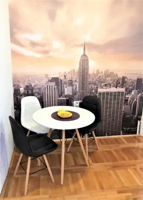 a table and chairs with a view of a city at Cicki Apartments II in Podgorica