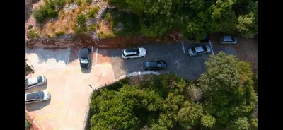 an overhead view of cars parked in a parking lot at Apartments Villa Čučuk in Budva