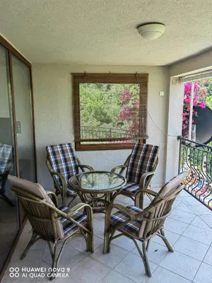 a patio with a glass table and chairs on a balcony at Apartments Villa Čučuk in Budva