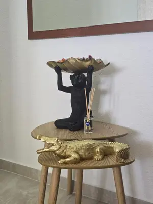 a figurine of a bear holding a plate of food on a table at Apartments Mediteran in Ulcinj