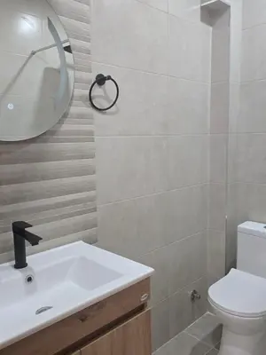 a bathroom with a white sink and a mirror at Apartments Mediteran in Ulcinj