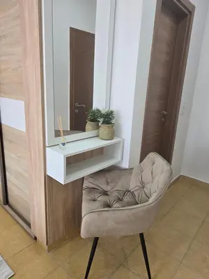 a mirror and a chair in a room at Apartments Mediteran in Ulcinj