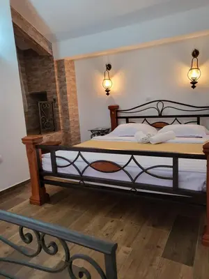 a bedroom with two beds and a bench at Apartments Mediteran in Ulcinj