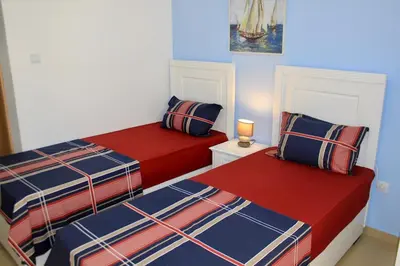 a bedroom with two beds with red and blue at Villa Rihter in Budva