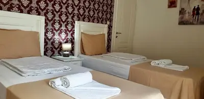 a room with two beds with towels on them at Villa Rihter in Budva