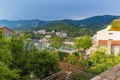 a view of a river with mountains in the background at Stone Beach Apartments in Pržno