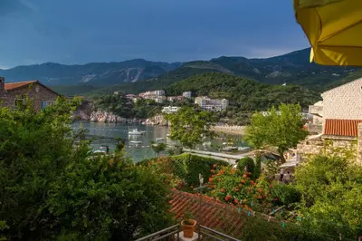a view of a river with boats in a city at Stone Beach Apartments in Pržno