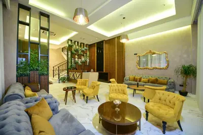 a living room with couches and a table and chairs at Hotel Lazaro in Podgorica