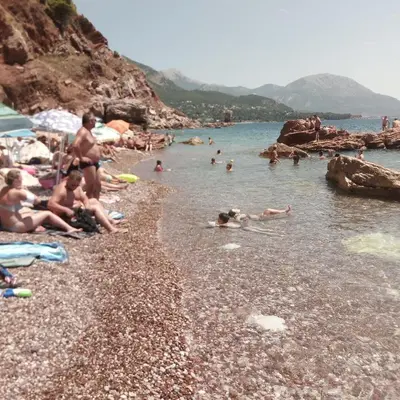 a group of people in the water at a beach at Apartmani Holiday Sutomore in Sutomore