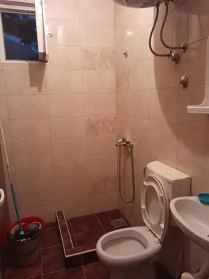 a bathroom with a toilet and a sink at Apartmani Holiday Sutomore in Sutomore