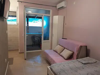 a room with a couch and a bed in it at Apartmani Holiday Sutomore in Sutomore