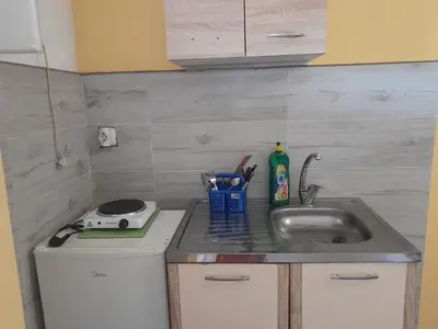a kitchen with a sink and a counter top at Apartmani Holiday Sutomore in Sutomore