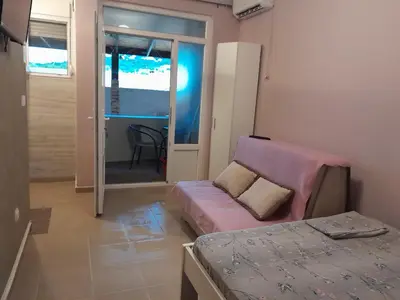 a living room with a couch and a bed at Apartmani Holiday Sutomore in Sutomore