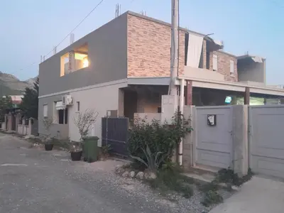 a white house with a gate and a fence at Apartmani Holiday Sutomore in Sutomore