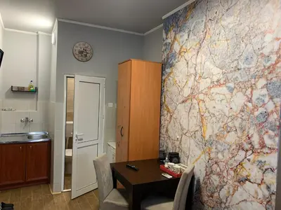 a room with a table and a map on the wall at Apartman Dacaa in Podgorica