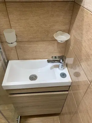 a bathroom with a white sink in a room at Apartman Dacaa in Podgorica