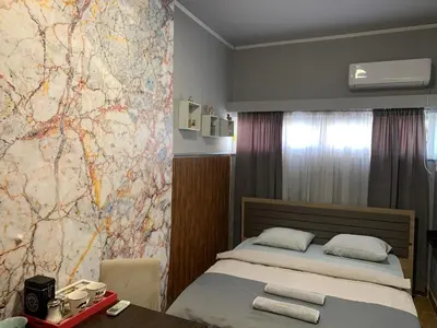 a bedroom with a bed and a map on the wall at Apartman Dacaa in Podgorica