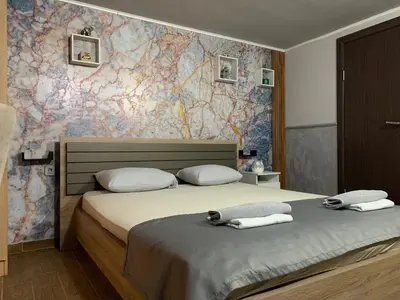 a bedroom with a bed with two towels on it at Apartman Daca in Podgorica