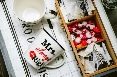 a cup of coffee next to a box of candy at Apartman Daca in Podgorica