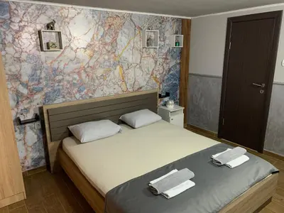 a bedroom with a bed with two towels on it at Apartman Daca in Podgorica