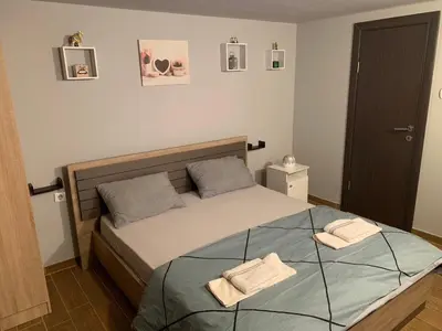 a bedroom with a bed with two towels on it at Apartman Daca in Podgorica