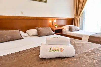 a hotel room with two beds with towels on them at Apartments Laguna in Ulcinj