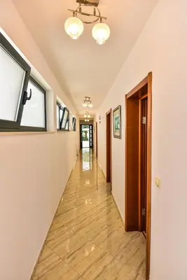 an empty hallway with a window and a long corridor at Apartments Laguna in Ulcinj