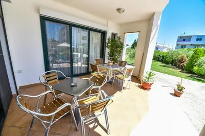 a patio with tables and chairs on a balcony at Apartments Laguna in Ulcinj