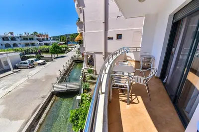 a balcony with chairs and a table on a building at Apartments Laguna in Ulcinj