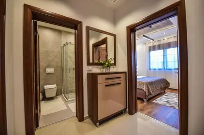 a bathroom with a shower and a toilet and a sink at Giardino Lux Apartments in Ulcinj