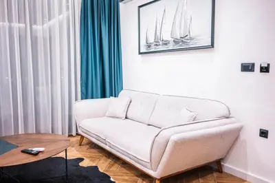 a living room with a couch and a table at Giardino Lux Apartments in Ulcinj