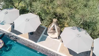 a group of umbrellas next to a swimming pool at Giardino Lux Apartments in Ulcinj