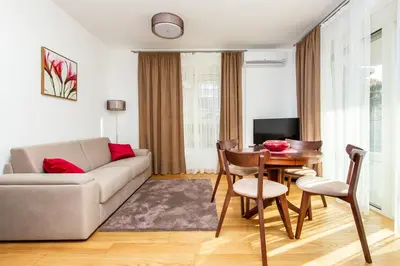 a living room with a couch and a table at Apartments LM RESIDENCE in Rafailovici