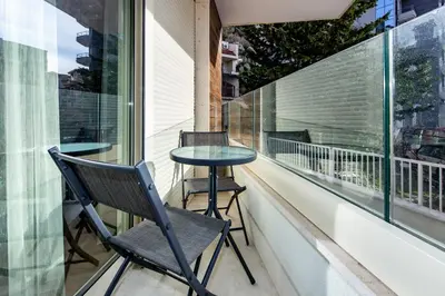 a balcony with a table and chairs on it at Apartments LM RESIDENCE in Rafailovici
