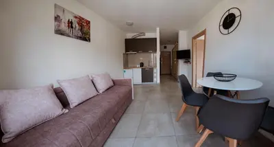 a living room with a couch and a table at Square Inn in Budva