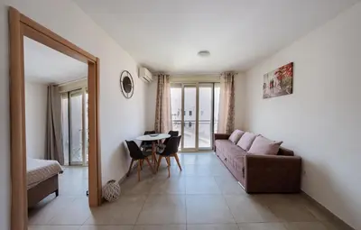 a living room with a couch and a table at Square Inn in Budva