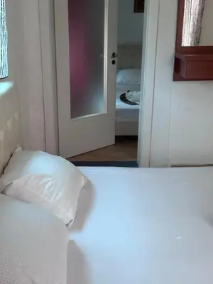 a bedroom with a bed with a white pillow at Apartments Monte in Ulcinj