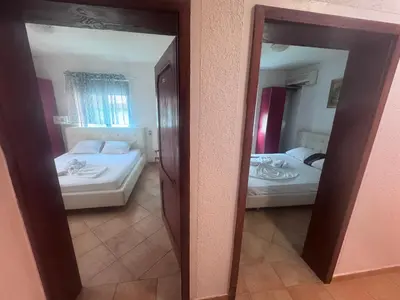 a reflection of a bedroom with two beds in a mirror at Apartments Monte in Ulcinj