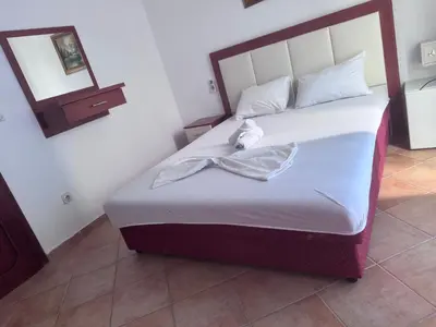 a bedroom with a bed in a room with a mirror at Apartments Monte in Ulcinj