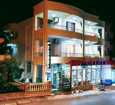 a building with a store front at night at Apartments Monte in Ulcinj