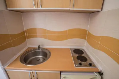 a small kitchen with a sink and a stove at Villa Elkom, Appartment 7 in Donji Štoj