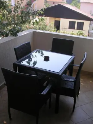 a black table and chairs with a cup on it at Villa Elkom, App 6 in Ulcinj