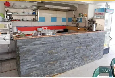 a kitchen with a brick counter in a kitchen at Villa Elkom, App 6 in Ulcinj