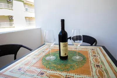 a bottle of wine and two wine glasses on a table at Villa Elkom, App 6 in Ulcinj