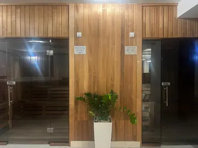 a plant in a vase in front of two elevators at Hotel Sato Conference & SPA Resort in Sutomore