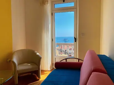 a living room with a couch and a window at Apartments Krš Medinski in Petrovac na Moru